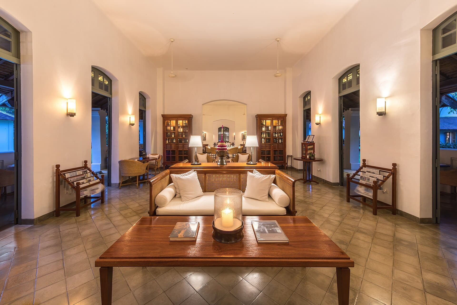 Hotel lounge with bar cabinets glowing at blue hour