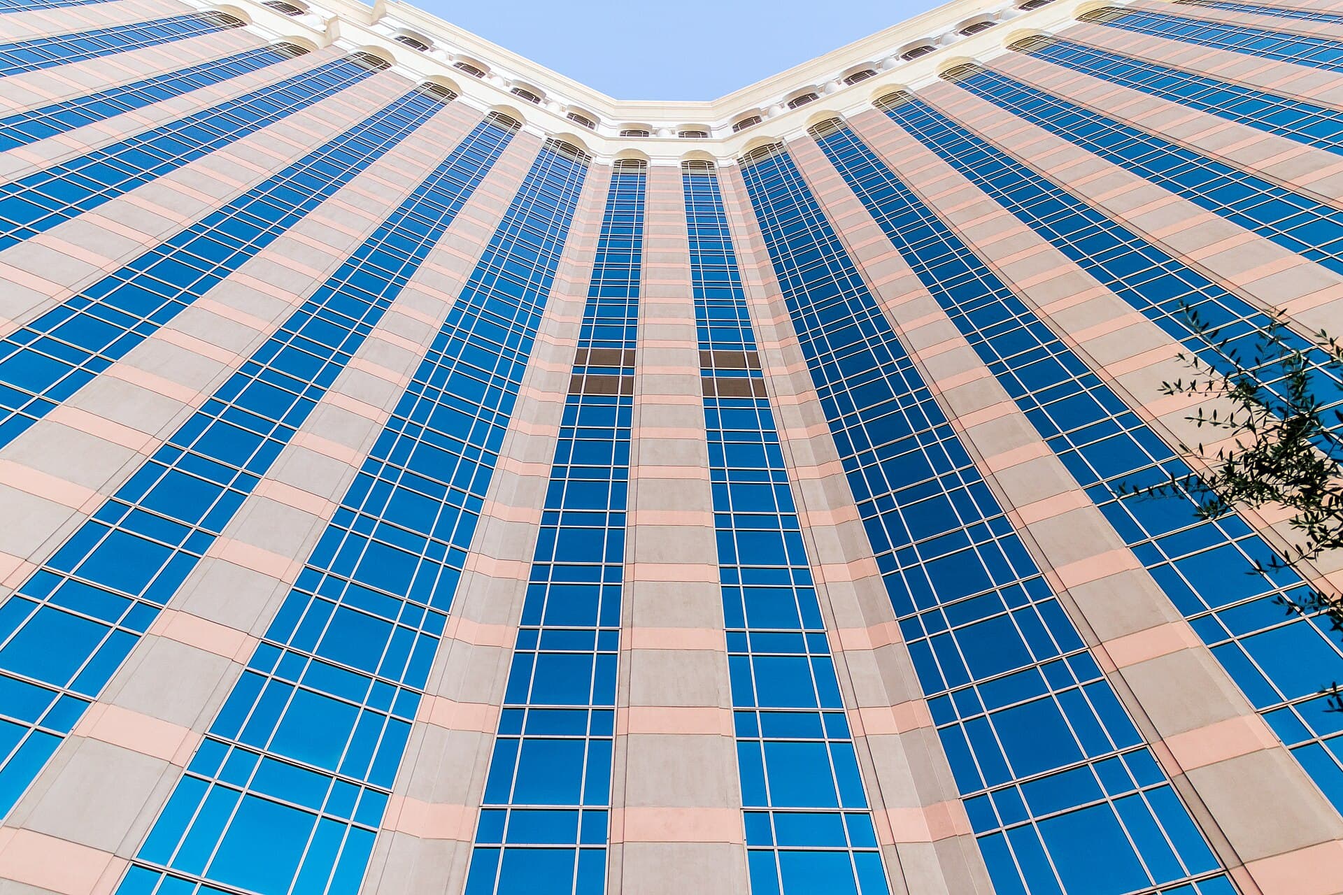 Modern hotel tower facade viewed from below