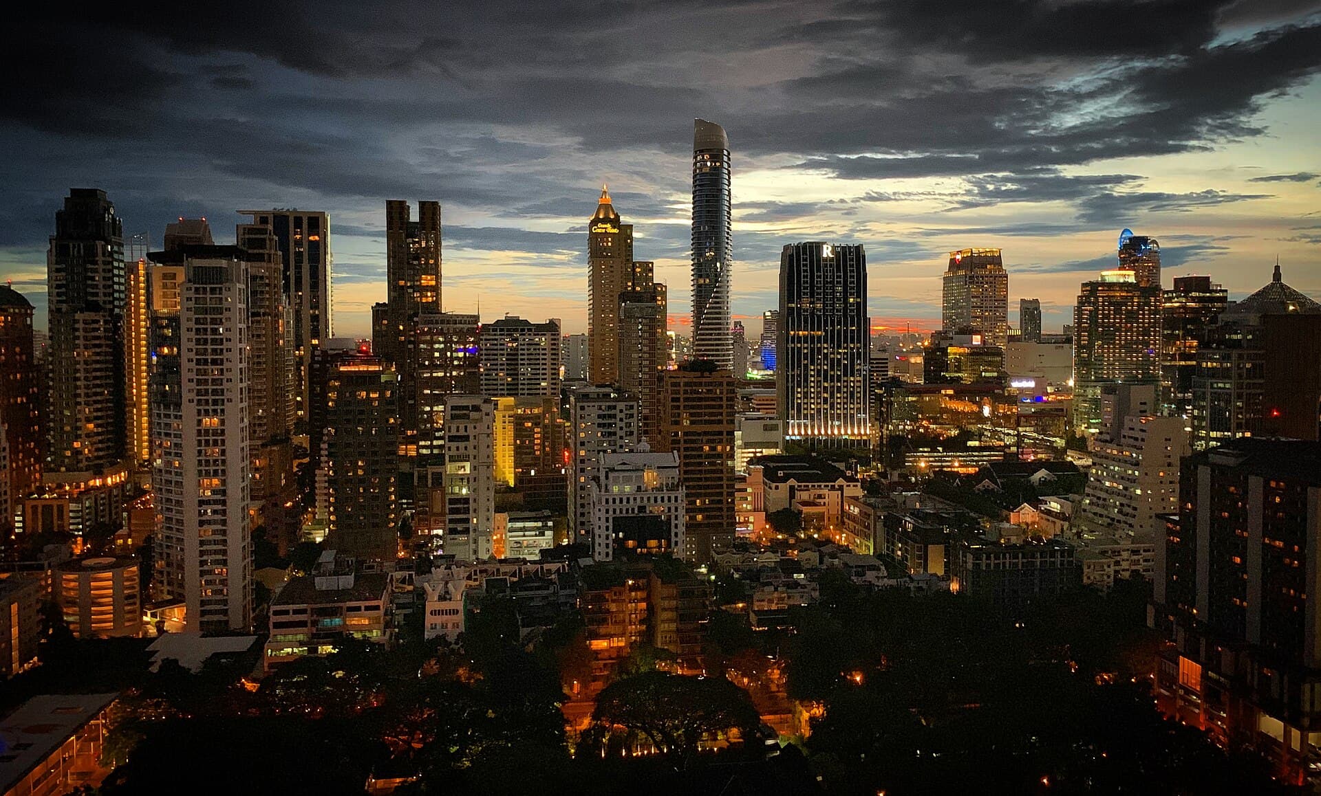 City skyline at dusk with warm sunset light over the towers