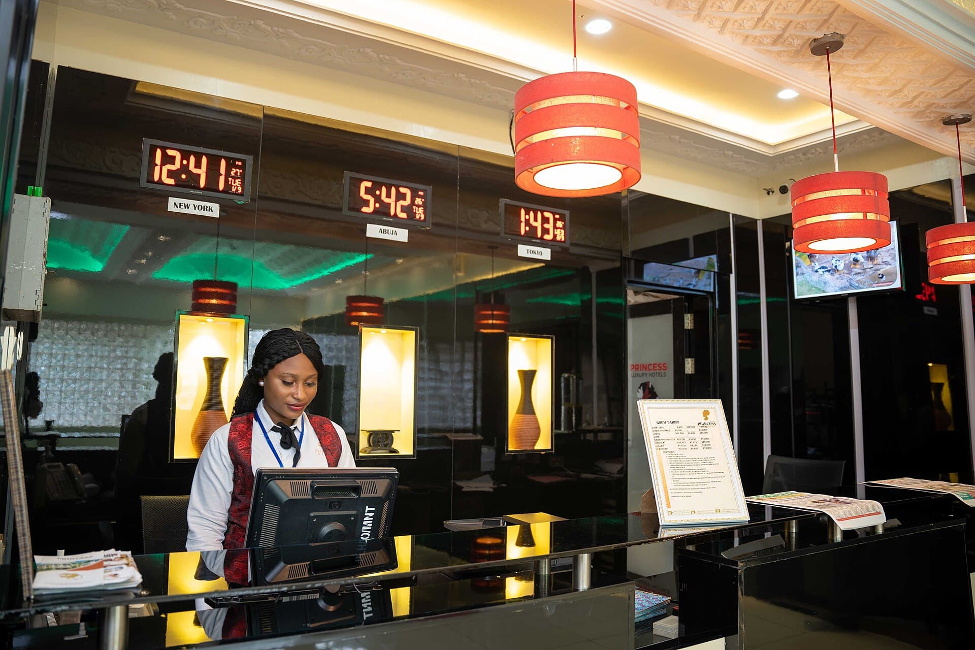 Hotel front desk with a staff member assisting a guest